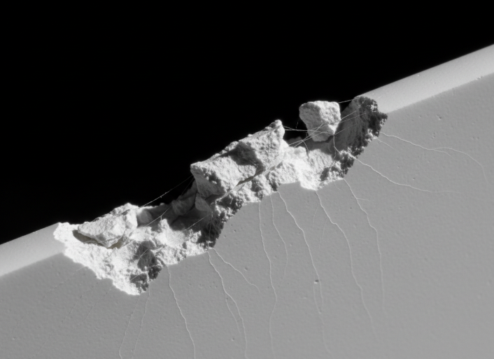Close-up of a clean, crack-free laser-cut alumina ceramic edge with micron-level precision