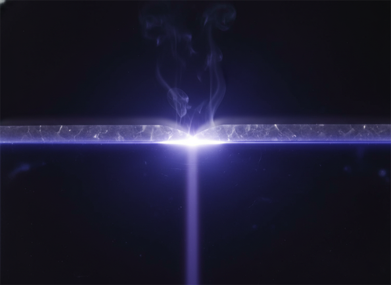 UV beam transmitting through transparent sapphire and absorbed at the GaN interface, showing selective absorption